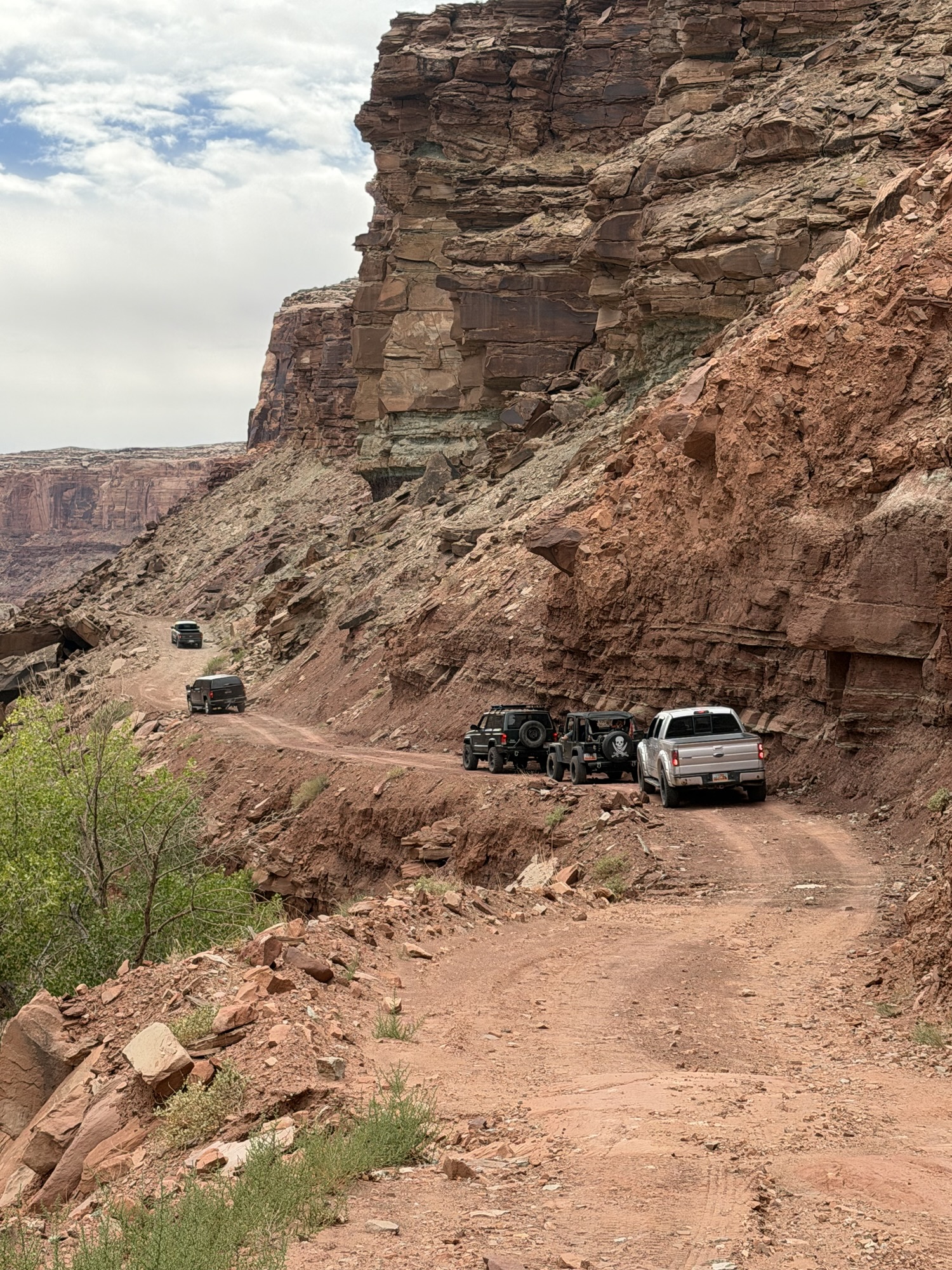 A line of off-roaders driving through Spring Canyon, Moab, UT